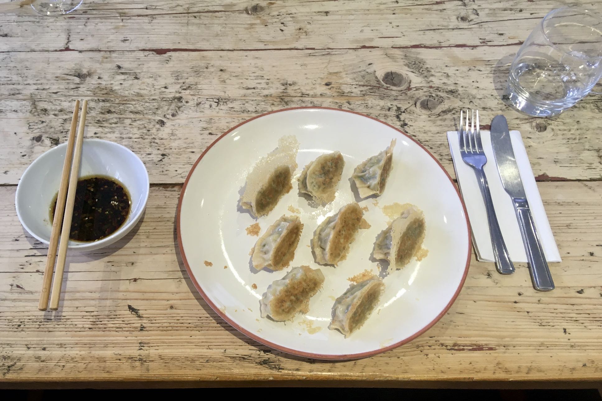Photo of eight gyoza with dipping source
