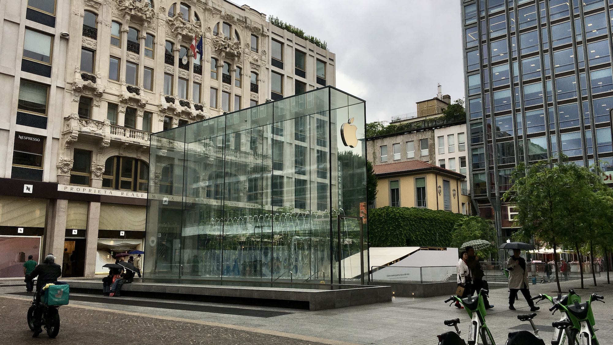 Photo of glass box above Apple store with fountain behind the box