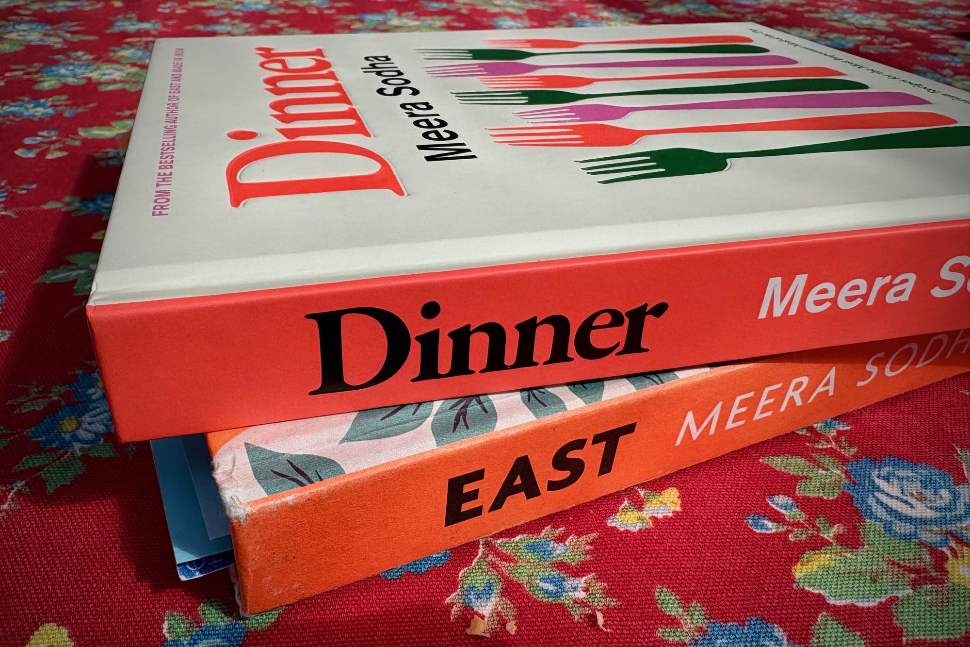 Photo of spines of two books: Dinner by Meera Sodha on top of East by Meera Sodha