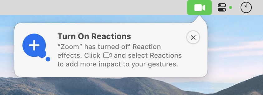 Screenshot of end of Mac menu bar. Popup from camera icon says “Turn On Reactions: Zoom has turned off Reaction effects. Click camera icon and select Reactions to add more impact to your gestures.”