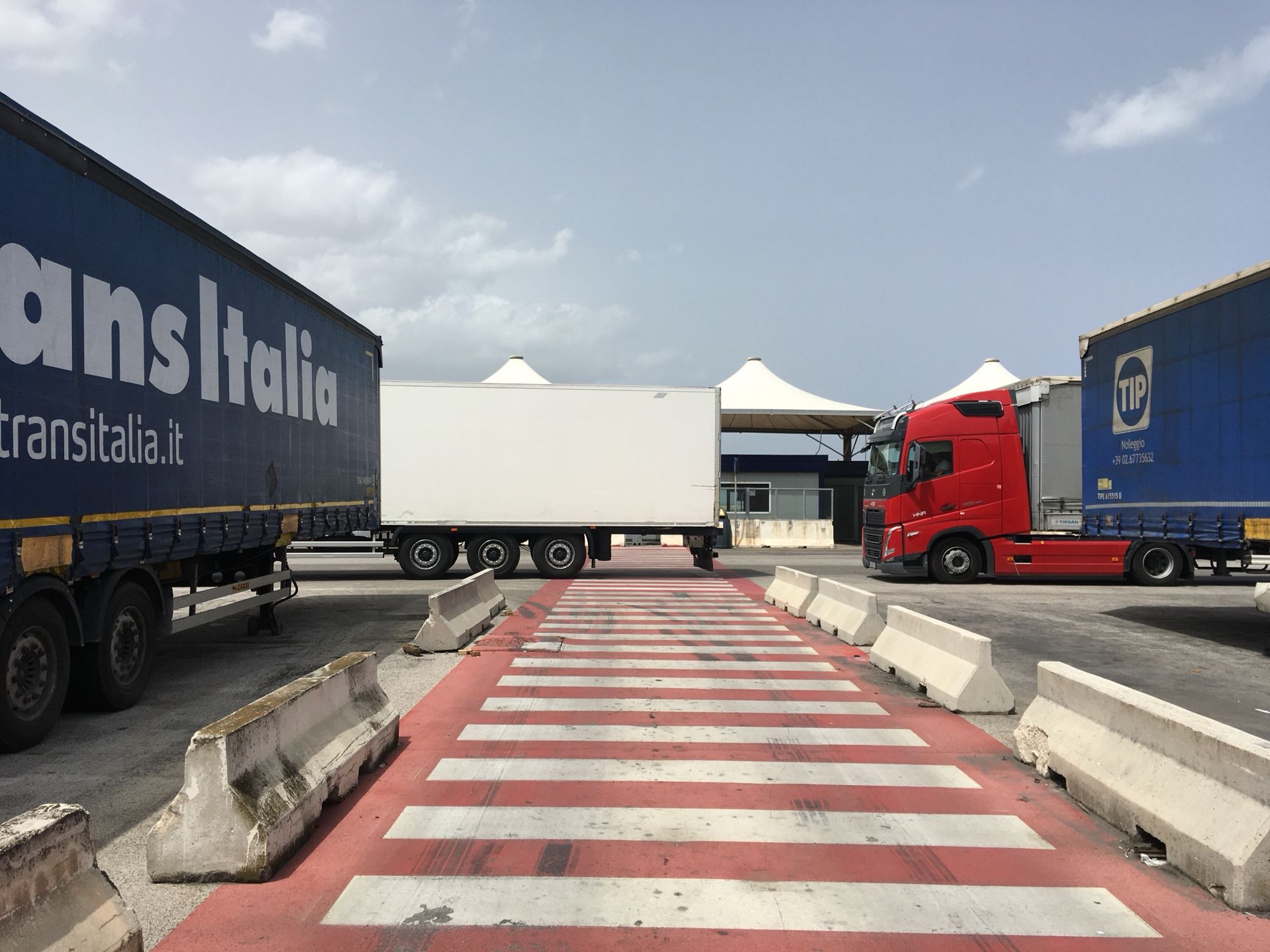 Photo of pedestrian crossing with lorries all around including over the crossing