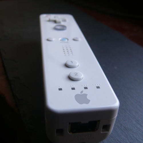 Photo of Wii Remote, edited to show an Apple logo rather than the Wii logo.